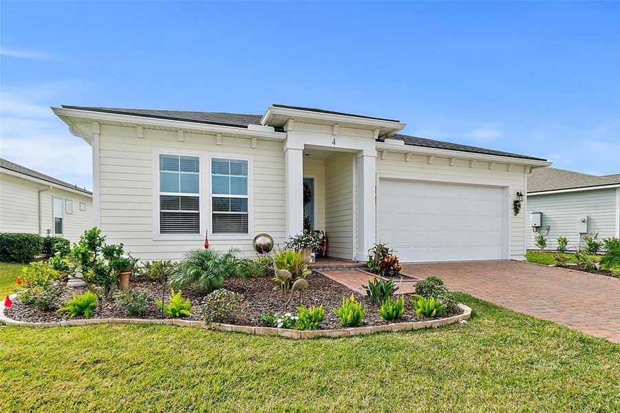 Front exterior of a new home in Reverie at Palm Coast, Palm Coast, FL, highlighting curb appeal (Image 22).