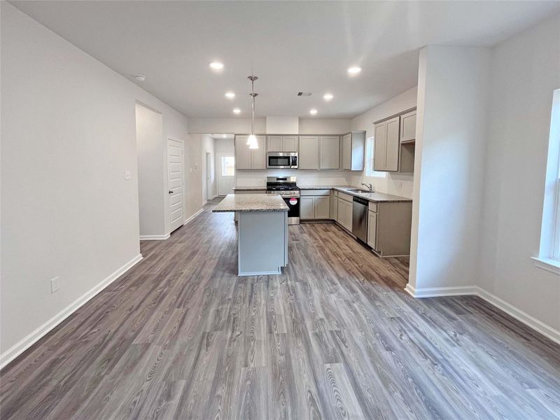 The Mockingbird II- Family Room into the Kitchen. Home under construction. Sample floor plan photo used for illustrative purposes only. Upgrades, selections options, windows and colors may vary.