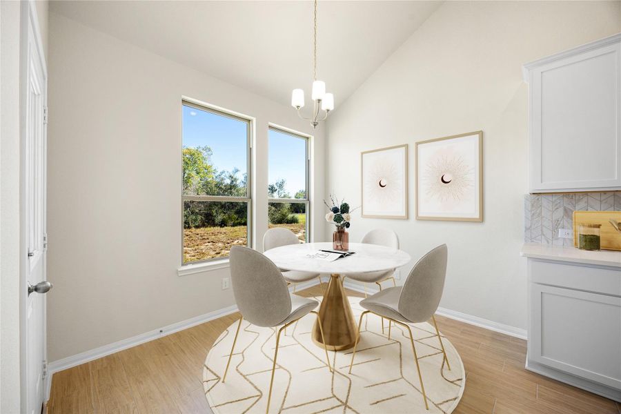 This charming and bright Dining Room offers an inviting spot for casual dining, situated perfectly by two large windows that provide abundant natural light and scenic outdoor views. The vaulted ceiling with a sleek pendant light fixture enhances the airy, open feel of the space. *Virtually Staged This charming and bright Dining Room offers an inviting spot for casual dining, situated perfectly by two large windows that provide abundant natural light and scenic outdoor views. The vaulted ceiling with a sleek pendant light fixture enhances the airy, open feel of the space. *Virtually Staged