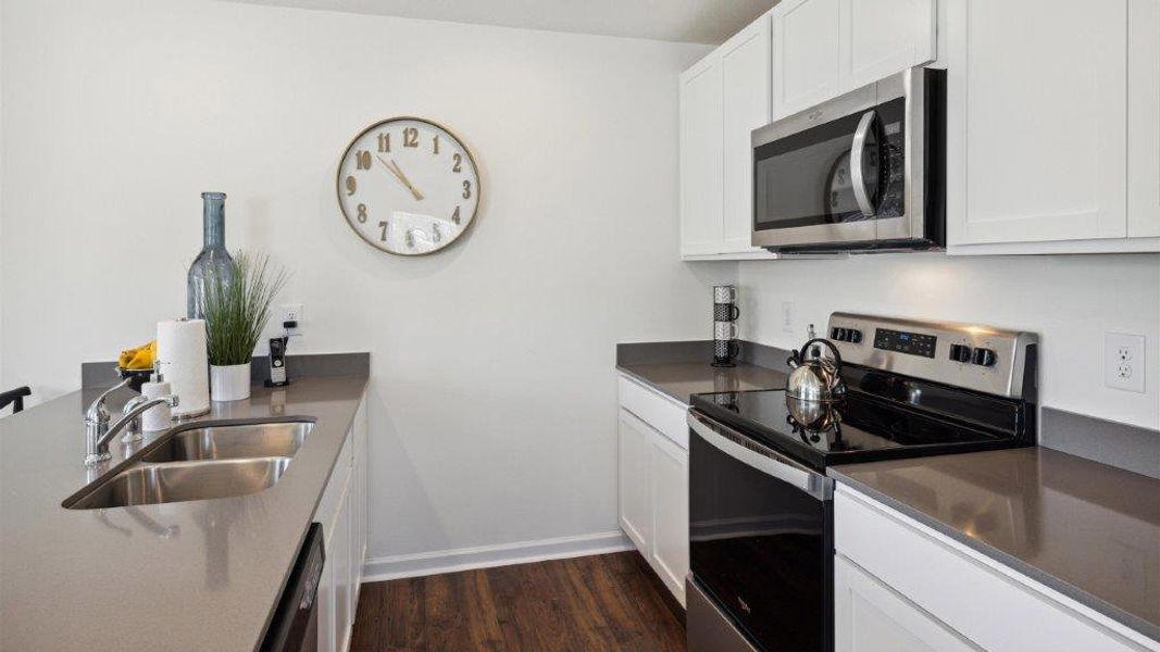 Representative furnished interior of a home built from the Altamont Townhome by D.R. Horton in Belcourt Landing, Cleveland (Image 9).