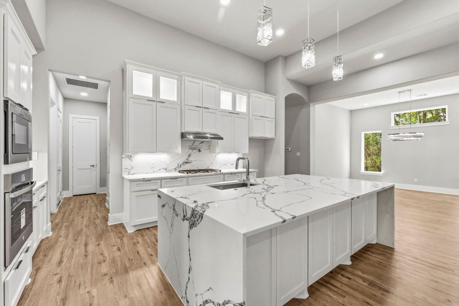 Thoughtfully positioned near the garage entry, the kitchen makes unloading groceries and everyday routines effortless.