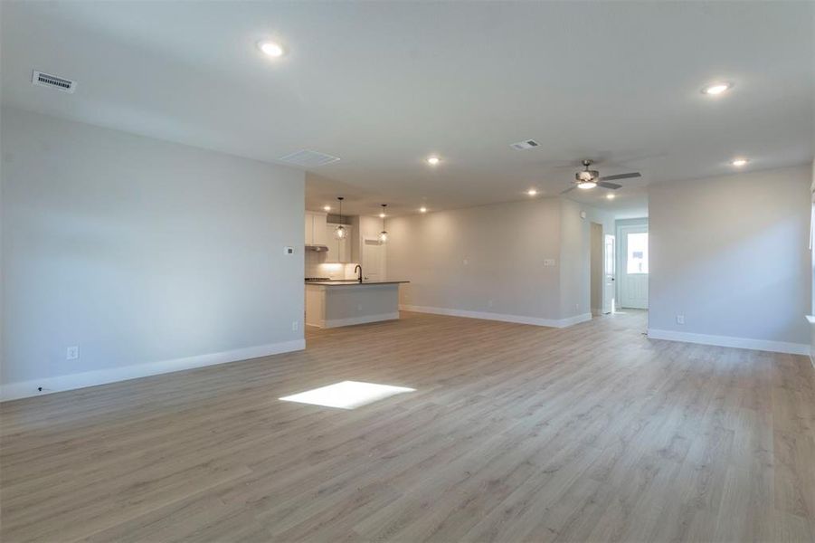 Unfurnished living room with light wood-style flooring, recessed lighting, and ceiling fan