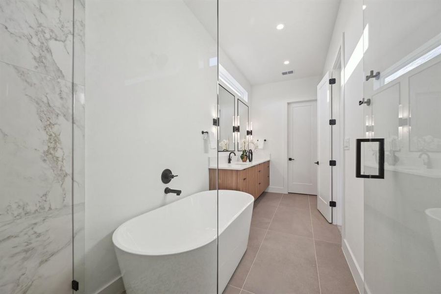 Bathroom with plus walk in shower, tile patterned floors, and vanity