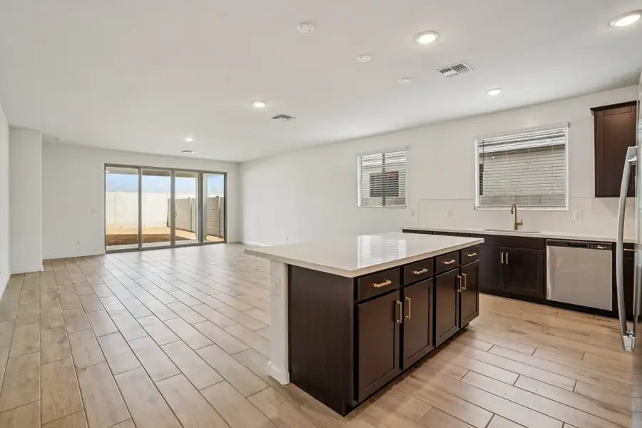 Kitchen, dining and great room. Finishes may vary by community.