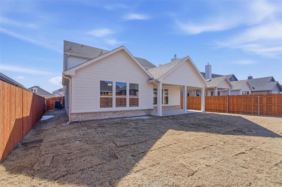 Rear view of property with a patio area and a fenced backyard