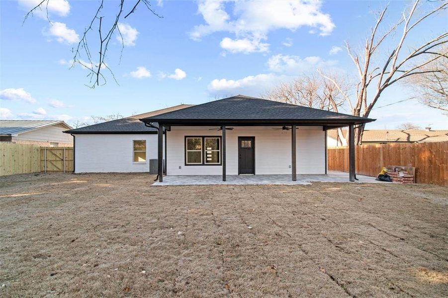 Back of property with ceiling fan and a patio