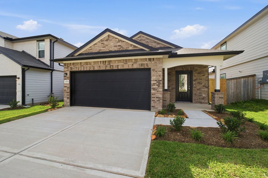Front exterior of a new home in The Pines at Seven Coves, Willis, TX, highlighting curb appeal (Image 16).