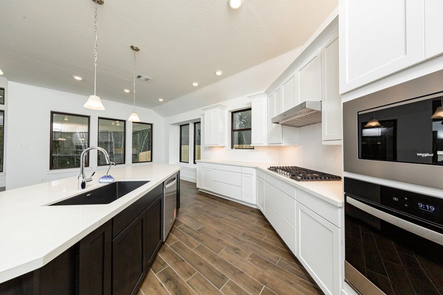 Discover the perfect blend of style and function in this modern kitchen, ready for your next culinary adventure. Equipped with high-end, stainless steel appliances, including a gas cooktop, built-in oven, and microwave.