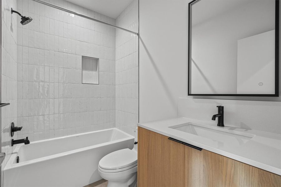 The bathroom on the 3rd level bathrooms echos the home’s modern aesthetic. The bathroom on the 3rd level bathrooms echos the home’s modern aesthetic.