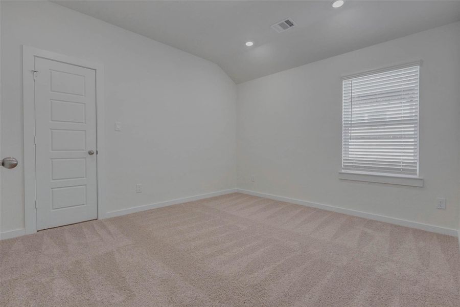 Flexible and spacious, this additional bedroom features a fresh white aesthetic, plush carpeting, and a standard closet with paneled door. Recessed lighting and a large window ensure the room stays bright and inviting perfect as a guest suite, office, or creative space.
