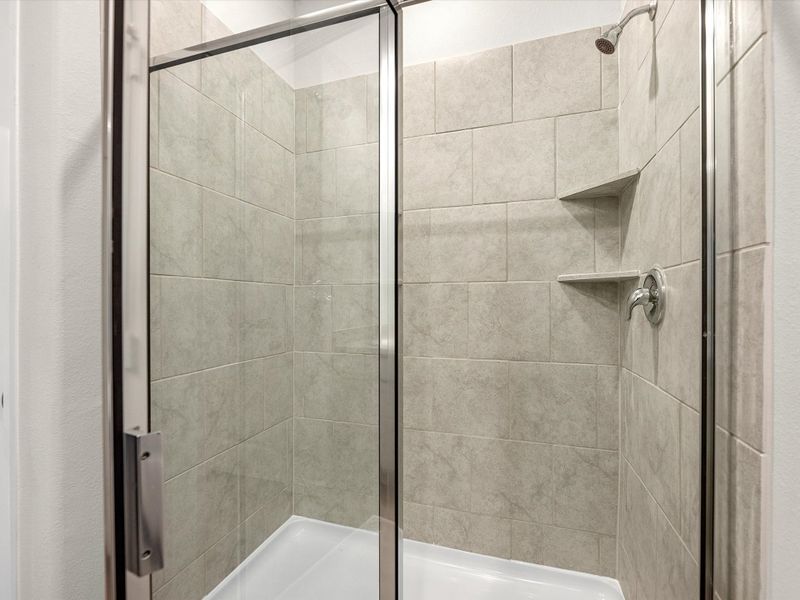 A shower with a glass door. A shower with a glass door.
