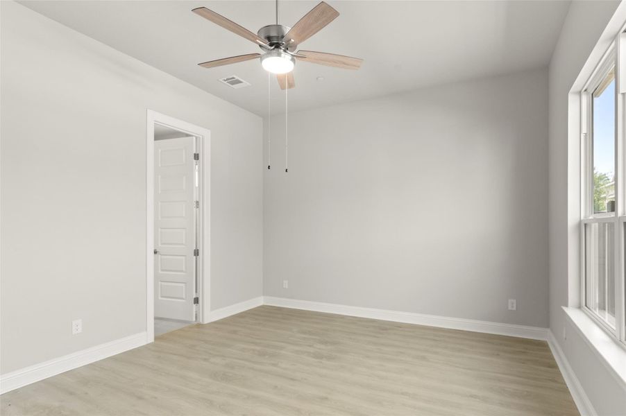 Unfurnished room with light wood-type flooring and ceiling fan Unfurnished room with light wood-type flooring and ceiling fan