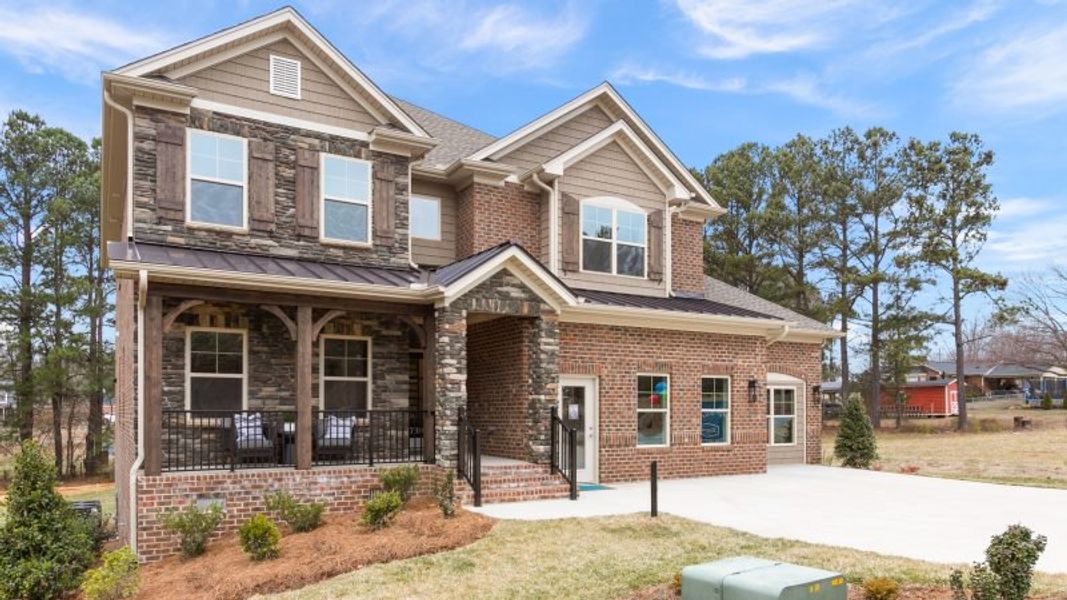 Front exterior of a new home in Preserve at Carriage Cove, Oak Ridge, NC, highlighting curb appeal (Image 27).