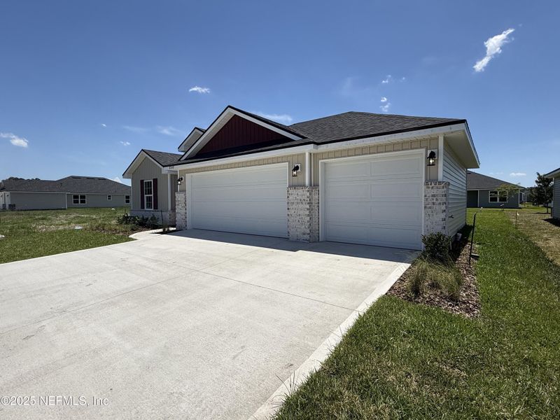 Front exterior of a new home in Summerglen, Jacksonville, FL, highlighting curb appeal (Image 25).