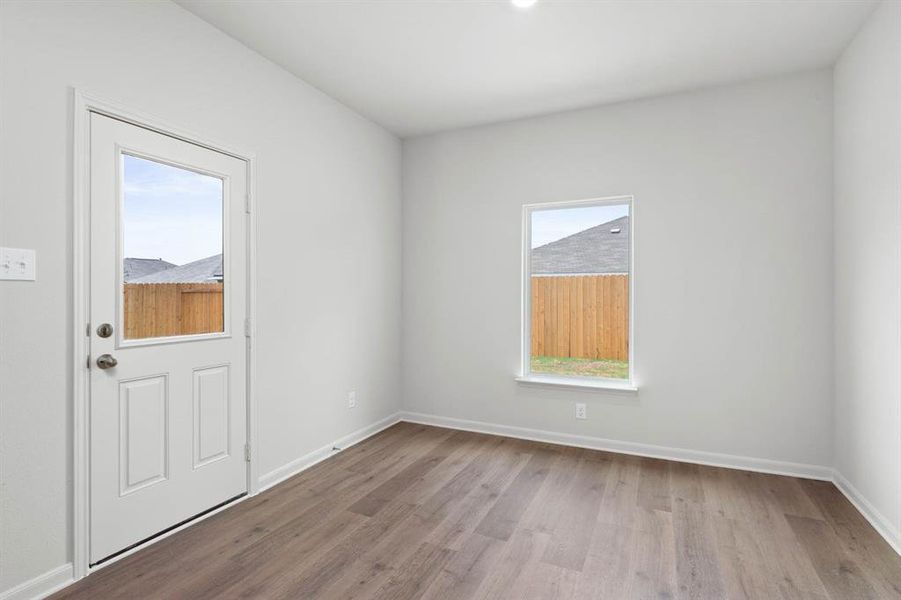 Empty room with baseboards and light wood-style floors Empty room with baseboards and light wood-style floors