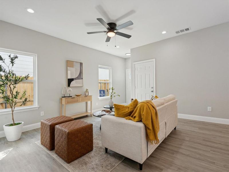 Living room featuring light hardwood / wood-style flooring and ceiling fan