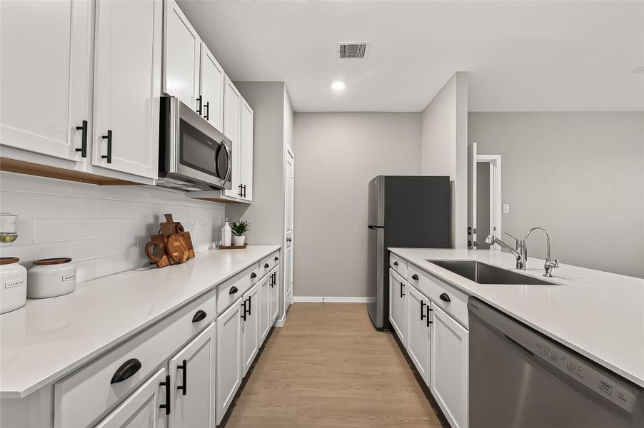 Guest suite kitchen with generous counter space, ample cabinetry, and stainless steel appliances. Guest suite kitchen with generous counter space, ample cabinetry, and stainless steel appliances.