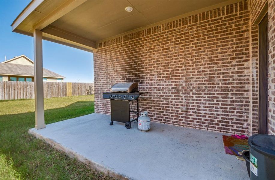 View of patio featuring a grill