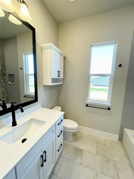 Second bath featuring vanity and toilet