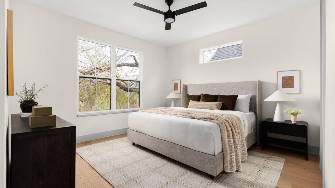 Bedroom with light wood-style floors and a ceiling fan