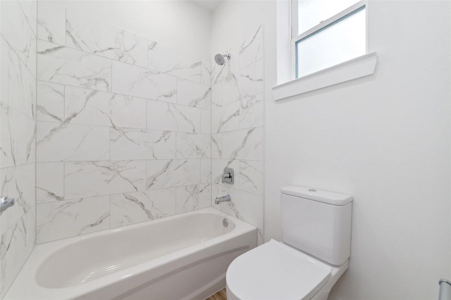 Guest Bath Showcasing Marble Tile