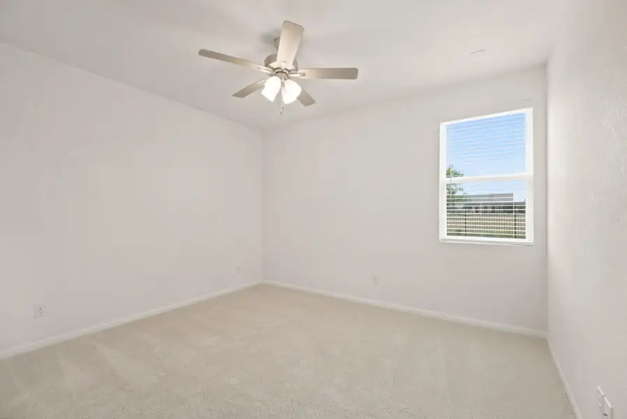 Plush carpeting and a large window define this comfortable private room.