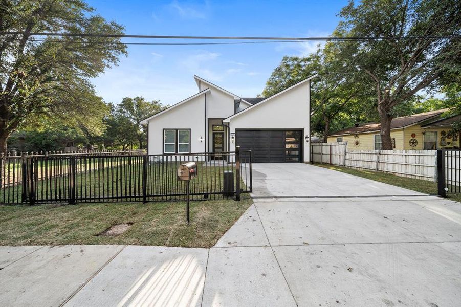 View of front of property with a front lawn and a garage