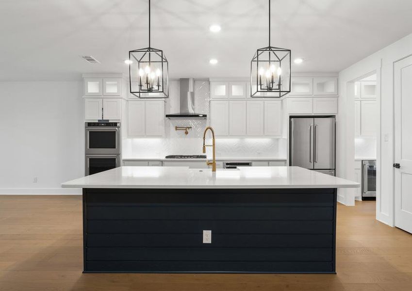 The kitchen has gorgeous white cabinetry.