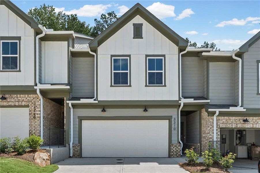 Front exterior of a new home in Ansley Towns, Cumming, GA, highlighting curb appeal (Image 1). Front exterior of a new home in Ansley Towns, Cumming, GA, highlighting curb appeal (Image 1).
