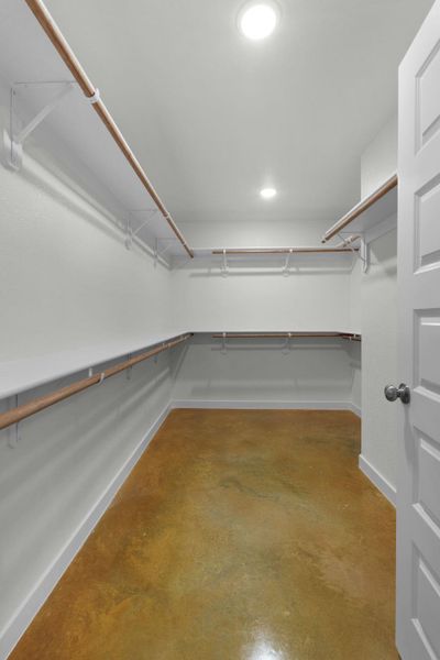 A well-lit walk-in closet offers extensive storage and organization possibilities.