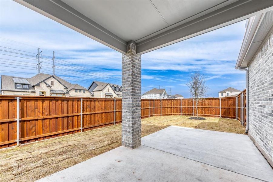 Fenced backyard featuring a residential view and a patio