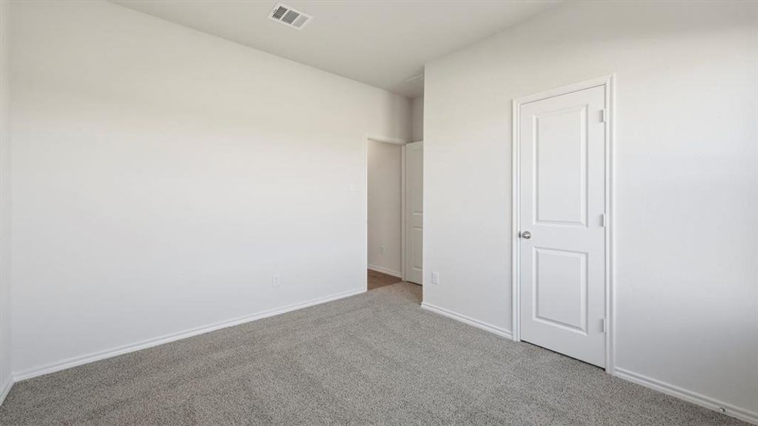 Unfurnished bedroom featuring carpet flooring and baseboards
