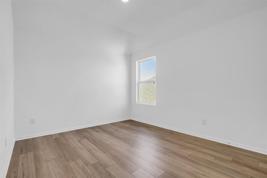 Upstairs Bedroom: One of three secondary bedrooms, featuring a private en suite full bathroom for added comfort and privacy. Upstairs Bedroom: One of three secondary bedrooms, featuring a private en suite full bathroom for added comfort and privacy.