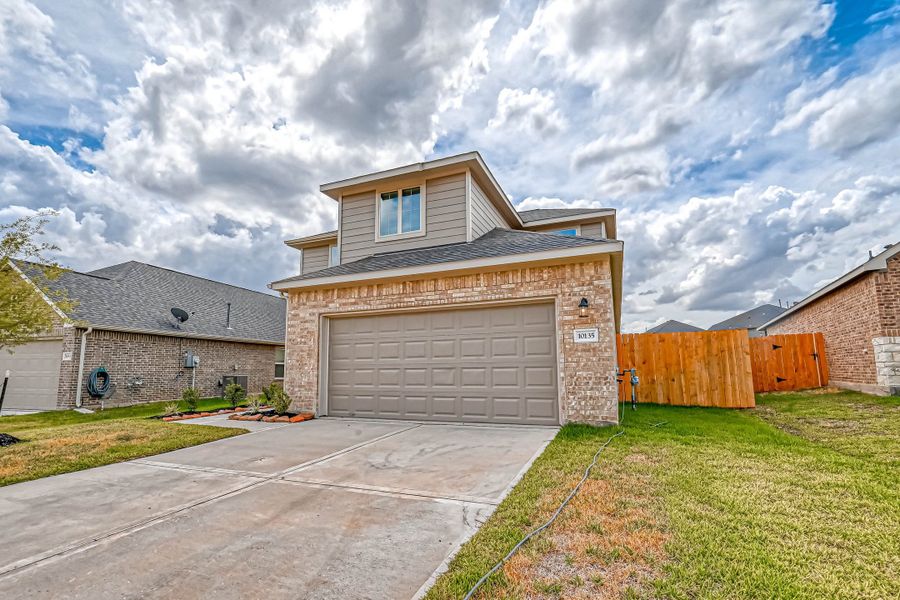 Representative exterior photo of a completed home built from the Floor Plan 2340 by Colina Homes in Grand Magnolia, Magnolia, TX (Image 23). Representative exterior photo of a completed home built from the Floor Plan 2340 by Colina Homes in Grand Magnolia, Magnolia, TX (Image 23).