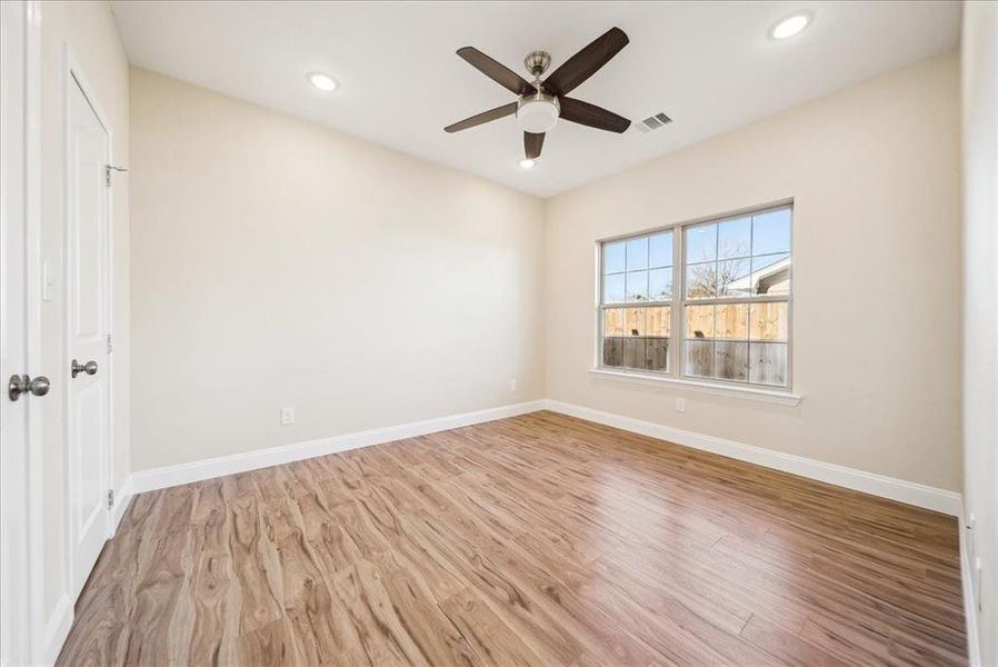 Spare room with ceiling fan and light hardwood / wood-style floors