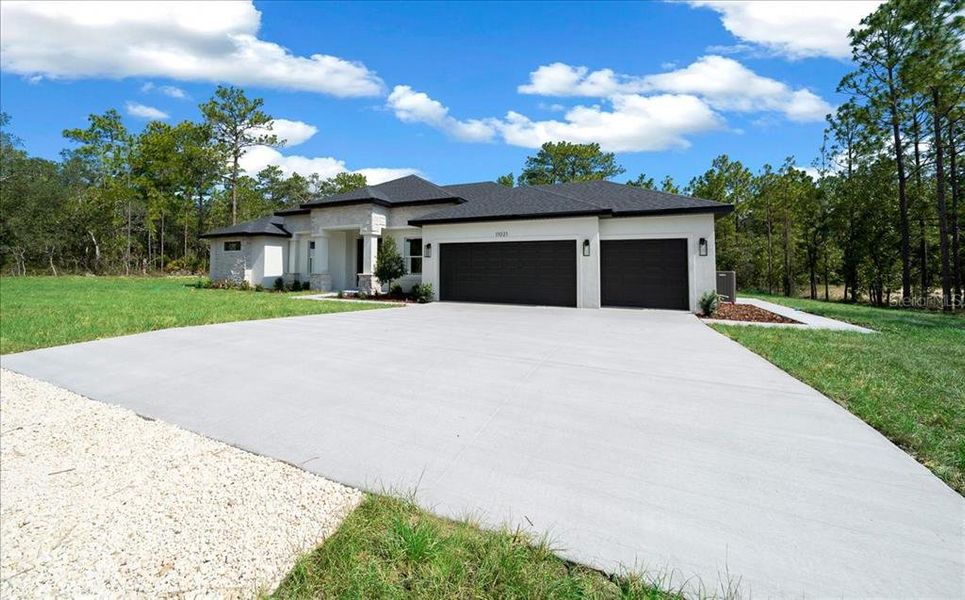 Front exterior of a new home in , Weeki Wachee, FL, highlighting curb appeal (Image 37). Front exterior of a new home in , Weeki Wachee, FL, highlighting curb appeal (Image 37).