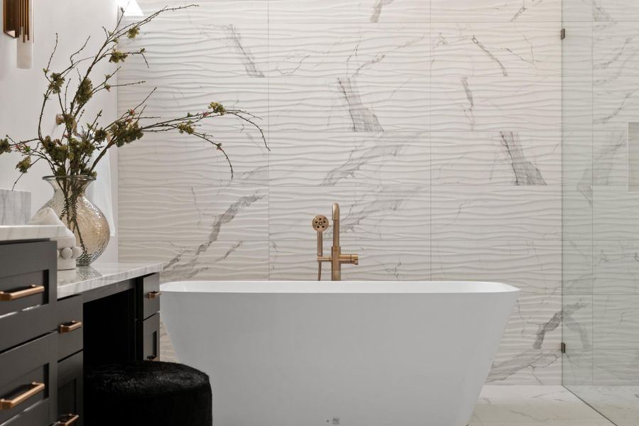 Positioned for ultimate serenity, the standalone soaking tub serves as a sculptural centerpiece, inviting you to unwind in a true resort-caliber setting