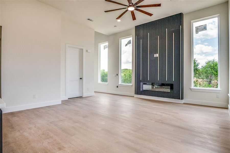 Unfurnished living room with ceiling fan, light wood-style flooring, and recessed lighting