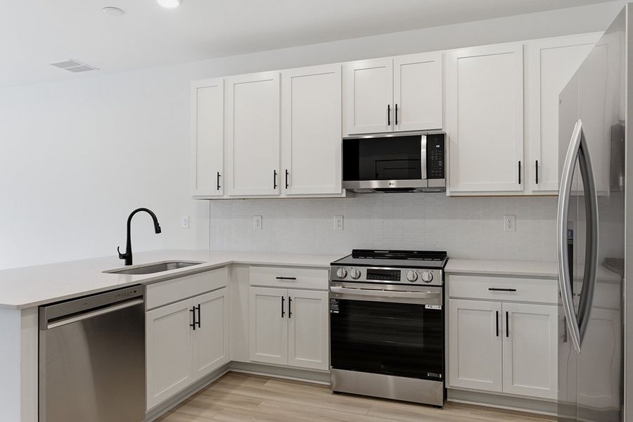 A kitchen with white cabinets. A kitchen with white cabinets.