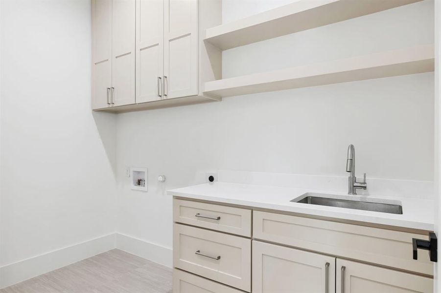 Laundry area featuring cabinet space, hookup for a washing machine, and gas dryer hookup Laundry area featuring cabinet space, hookup for a washing machine, and gas dryer hookup