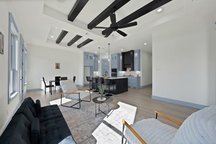 Living room featuring beamed ceiling, recessed lighting, light wood-style flooring, and ceiling fan