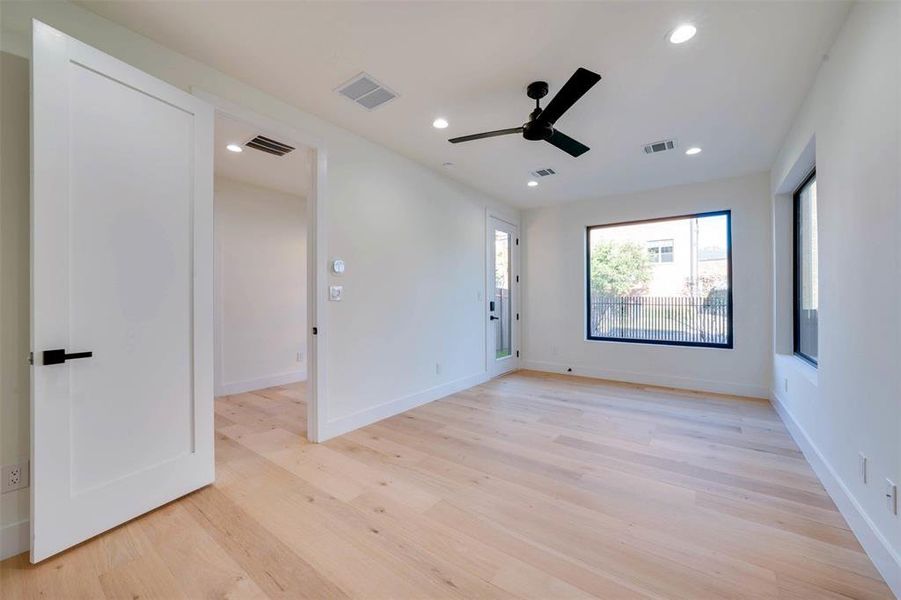 Unfurnished room with light wood-type flooring and ceiling fan