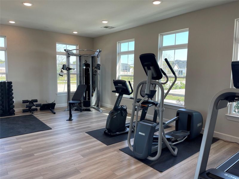 Stay active and healthy in the community fitness center, featuring free weights, a treadmill, stationary bike, and elliptical for your daily workouts.