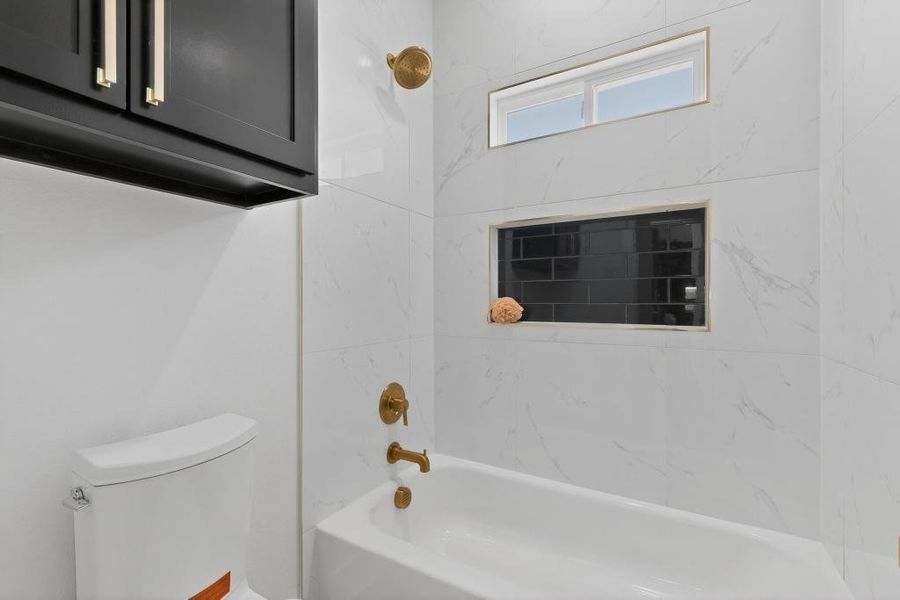 Hall Bathroom with toilet and shower / bath combination