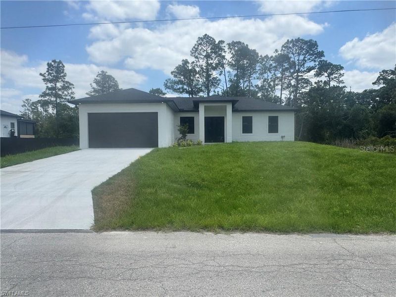 Front exterior of a new home in , Lehigh Acres, FL, highlighting curb appeal (Image 1). Front exterior of a new home in , Lehigh Acres, FL, highlighting curb appeal (Image 1).
