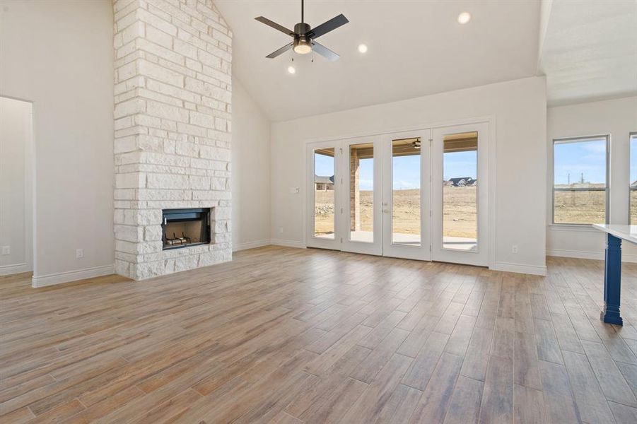 Beautiful stone to ceiling fireplace with a wood beam across the top.
