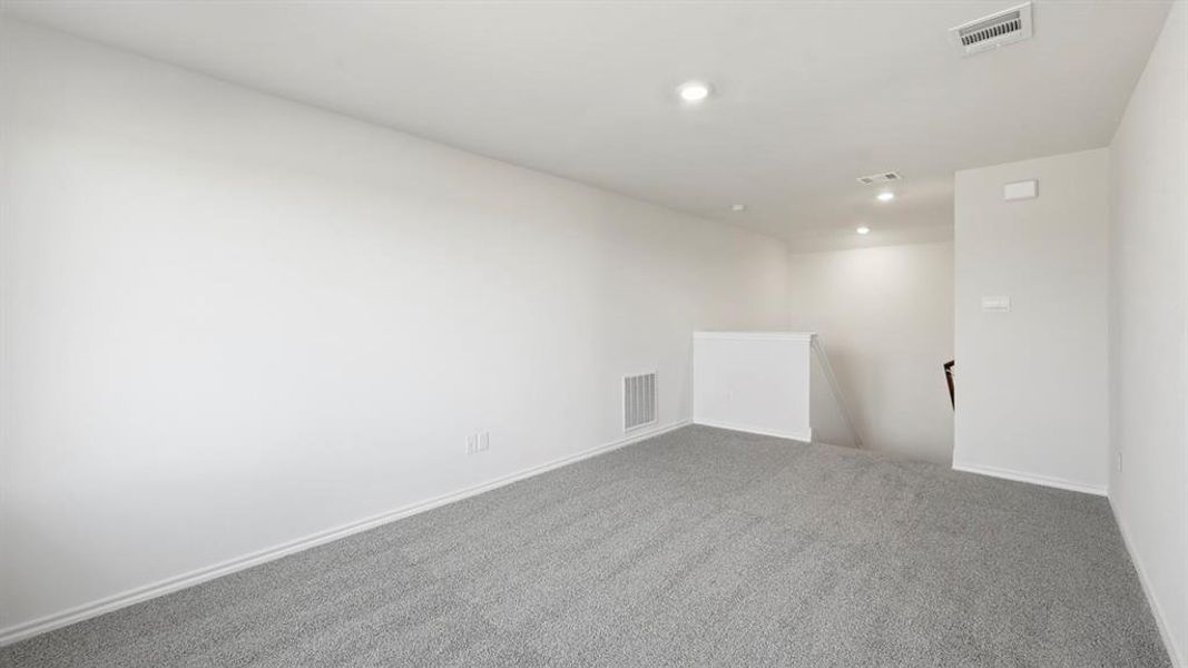 Carpeted empty room featuring baseboards and recessed lighting Carpeted empty room featuring baseboards and recessed lighting