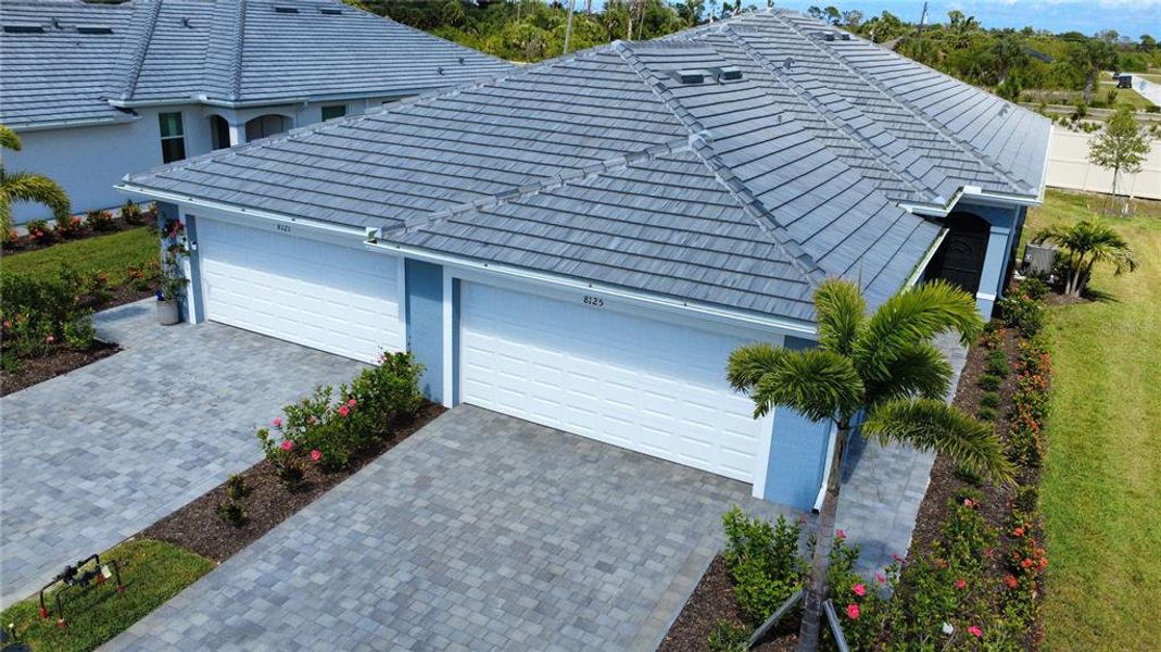 Front exterior of a new home in Palm Lake at Coco Bay, Englewood, FL, highlighting curb appeal (Image 20). Front exterior of a new home in Palm Lake at Coco Bay, Englewood, FL, highlighting curb appeal (Image 20).