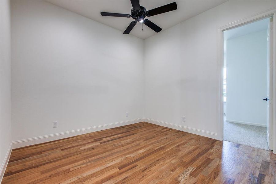 Empty room featuring light wood-type flooring and ceiling fan