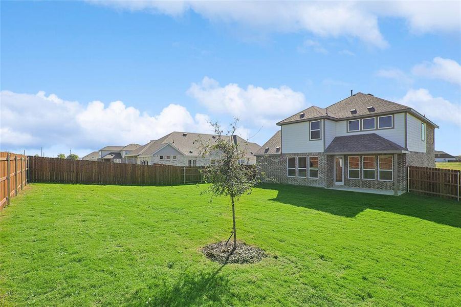 Rear view of property featuring a yard